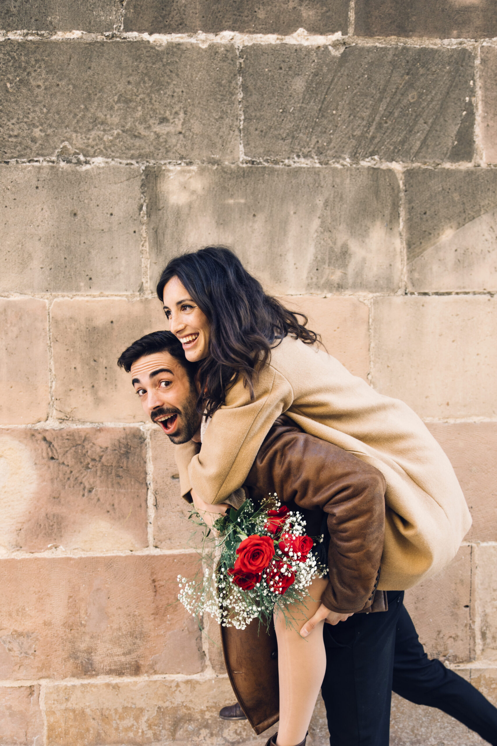 cheerful-man-carrying-woman-back