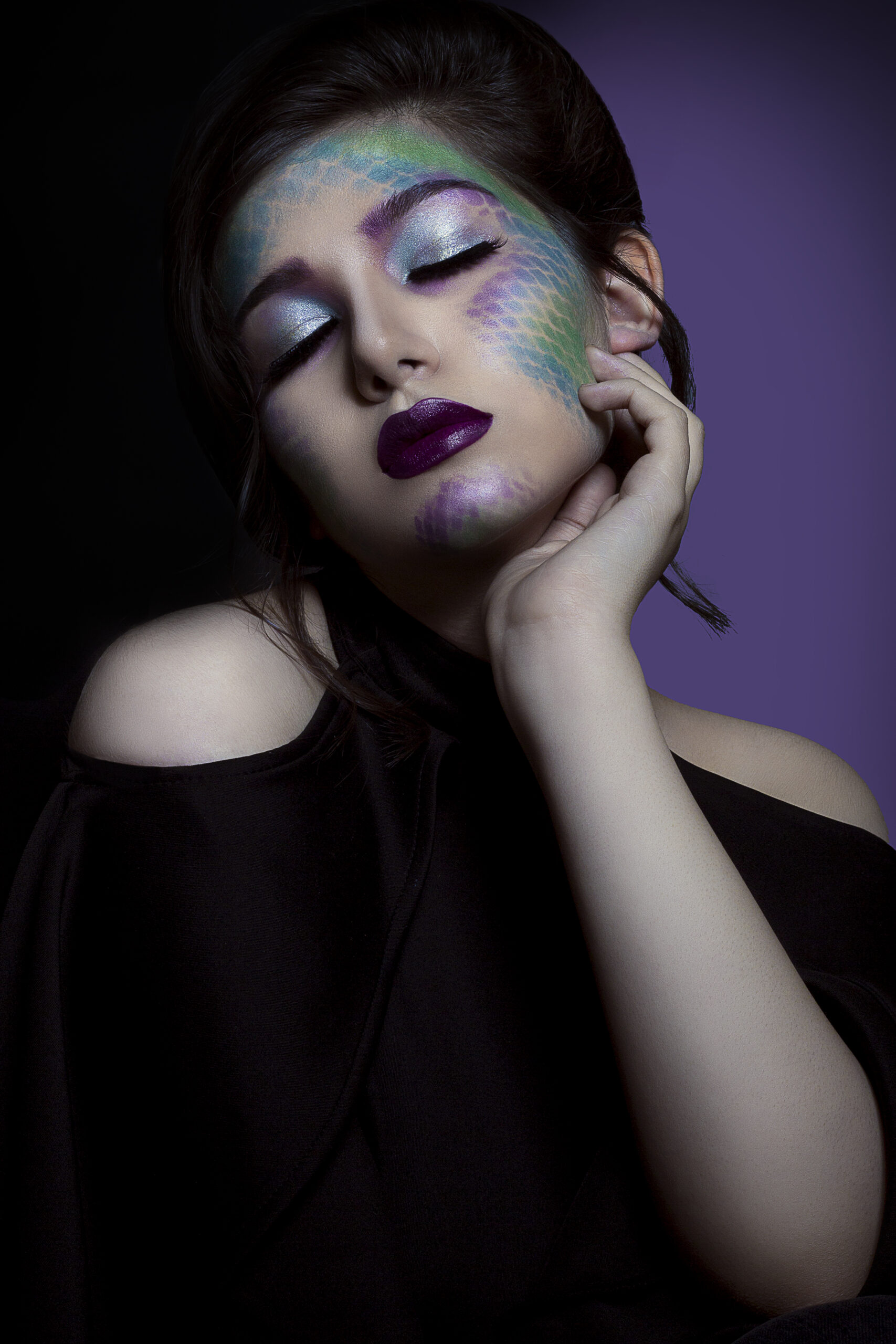 Female model promoting gothic color cosmetics and outfits